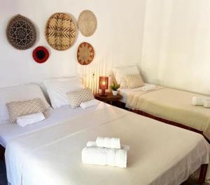 a room with two beds with towels on them at icaraizinho villa soleil in Amontada