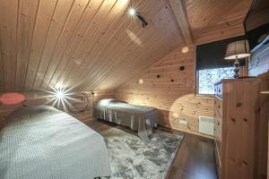 Katil atau katil-katil dalam bilik di Lomavuokra Villa Nuottirakka, Levi