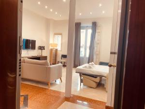 a living room with a couch and a table at Putignani Exclusive Suite in Bari