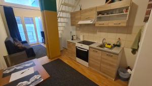 a small kitchen with a sink and a stove at Cozy Mezonette near City Center Athens near Metro Station in Athens