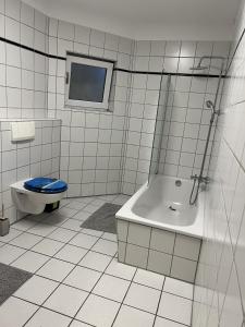 a bathroom with a toilet and a tub and a sink at Sunset Apartment mit Rheinblick in Urbar in Urbar