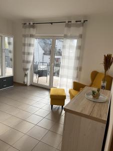 a living room with a kitchen with a table and a couch at Sunset Apartment mit Rheinblick in Urbar in Urbar
