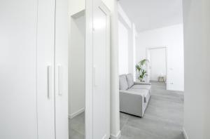 a living room with white walls and a couch at Casa MAC - New and Confortable - Near the Center and Station in Verona