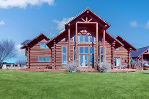 a log cabin with a large window at Lake Springs Luxury in Glenwood Springs