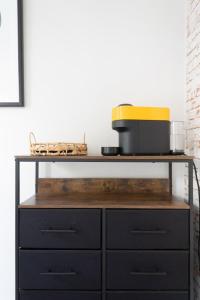 a black cabinet with a counter top with aounter at Trendy & Central 2BD Flat -Brick Lane Shoreditch! in London