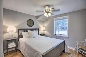 a bedroom with a bed with a ceiling fan and a window at Hot Tub! Charming Cottage With Horse Farm View in Afton