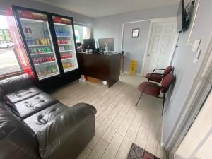 a living room with a couch and a refrigerator at Palmsbythebeach in Myrtle Beach