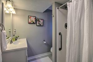 a bathroom with a white sink and a shower at Hot Tub! Charming Cottage With Horse Farm View in Afton