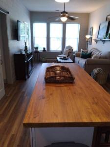 a living room with a wooden table in a room at Cozy Getaway in Lincoln! 