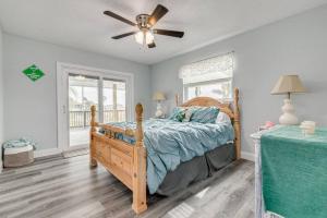 a bedroom with a wooden bed and a ceiling fan at Huge discounts though end of the 2023! in Hernando Beach