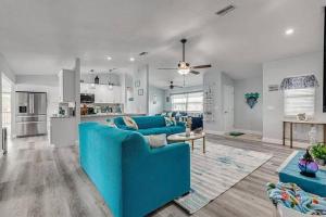 a living room with a blue couch and a kitchen at Huge discounts though end of the 2023! in Hernando Beach