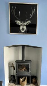 a picture of a deer head over a fireplace at Castle Yard Cottage in Knaresborough