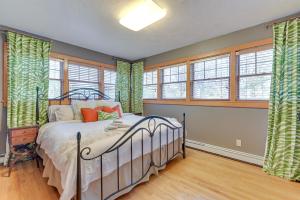 a bedroom with a bed in a room with windows at Hike and Golf Near Luxe Windham Getaway with Hot Tub in Windham