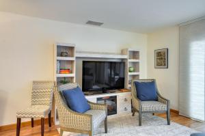 a living room with three chairs and a television at Portland Condo with Hot Tub Access, Near Downtown! in Portland