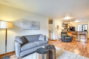 a living room with a couch and a table at Portland Condo with Hot Tub Access, Near Downtown! in Portland