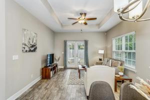 a living room with a couch and a ceiling fan at Lovely Town-home in Pensacola in Pensacola