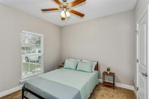 a bedroom with a bed and a ceiling fan at Lovely Town-home in Pensacola in Pensacola