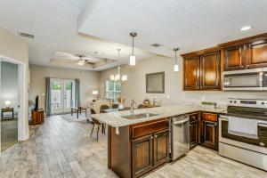a kitchen with wooden cabinets and a kitchen island at Lovely Town-home in Pensacola in Pensacola