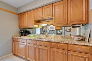 a kitchen with wooden cabinets and a counter top at Frank Lloyd Wright Condo at Biltmore Golf Course in Phoenix