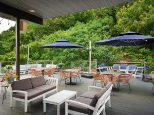 a patio with tables and chairs and umbrellas at The Waters Hot Springs, Tapestry Collection by Hilton in Hot Springs