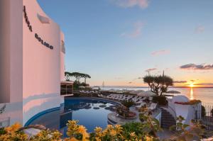 a view of a resort with a pool and the ocean at Punta Molino Beach Resort & Thermal Spa in Ischia