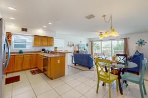 a kitchen and dining room with a table and chairs at Captain's Cove 304 in Clearwater Beach