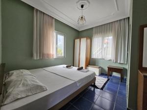 een slaapkamer met een bed en 2 ramen bij BelHomes Apart in Beldibi