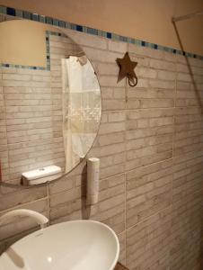 a bathroom with a mirror and a sink at Ára apart in Puerto Iguazú