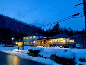 a house in the snow at night at Hakuba park hotel - Vacation STAY 96005v in Hakuba