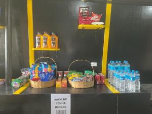 una tienda con cestas de bebidas y botellas de agua en Cabanas Capivari Lodge en Campos do Jordão