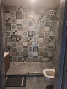 a bathroom with a toilet and a sink at SEA FACING modern 3-bedroom apartment, Umdloti in Umdloti +11 photos