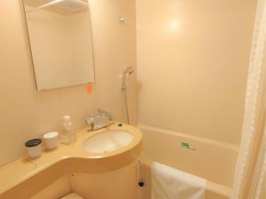 a bathroom with a sink and a mirror and a tub at Hotel Area One Oita - Vacation STAY 99740v in Oita