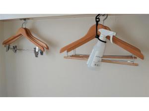 a room with wooden hangers and a white bottle hanging from a ceiling at Hotel Area One Oita - Vacation STAY 99740v in Oita +85 photos