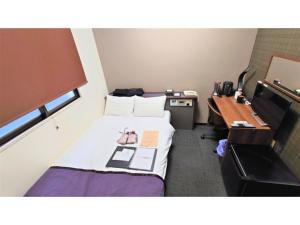 a small room with a bed and a desk at Hotel Area One Oita - Vacation STAY 99724v in Oita