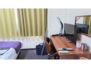 a hotel room with a desk with a computer on it at Hotel Area One Oita - Vacation STAY 99724v in Oita