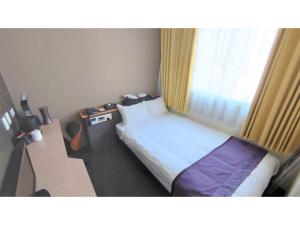 a hotel room with a bed and a window at Hotel Area One Oita - Vacation STAY 99724v in Oita