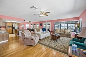 a living room with a couch and a table at Waterfront home with pool and gameroom! in Hernando Beach