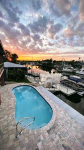 a large swimming pool with a view of a marina at Waterfront home with pool and gameroom! in Hernando Beach