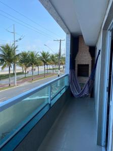- un balcon avec un hamac dans un bâtiment dans l'établissement Casa Condomínio FRENTE PARA O MAR, à Praia Grande