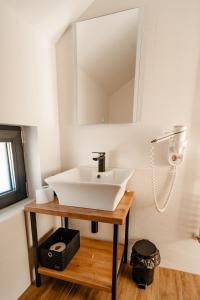 a bathroom with a white sink and a mirror at Casa din livada in Dragomireşti +27 photos