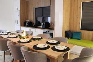 a dining room with a table and chairs at Casa din livada in Dragomireşti