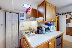 a kitchen with a sink and a microwave at 60073 Wallowa Lake Hwy (lower unit) in Joseph