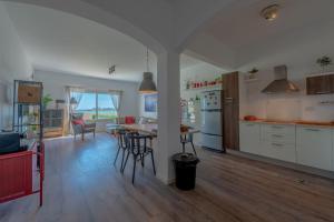 a kitchen and living room with a table and chairs at unique flat_ garden and lagoon in Hurghada