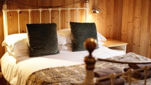 a bedroom with a bed with two pillows on it at Slemish Apt in Morzine