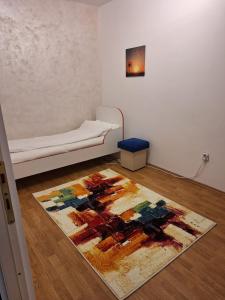 um quarto com uma cama e um tapete no chão em A&M em Târgu-Mureş