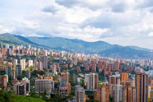 a large city with many tall buildings and mountains at Luxury, 2 Bdr, Pv Balconie, Top View El Poblado in Medellín