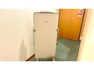 a white refrigerator in a hallway with a door at Hotel Sunroute Patio Goshogawara - Vacation STAY 30369v in Goshogawara