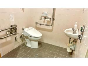 a bathroom with a toilet and a sink at Hotel Sunroute Patio Goshogawara - Vacation STAY 30369v in Goshogawara