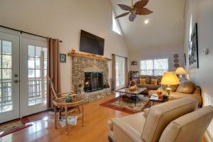 a living room with a couch and a fireplace at Enchanted Forest Cottage with Hot Tub! in Hiawassee