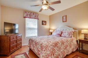 a bedroom with a bed and a flat screen tv at Enchanted Forest Cottage with Hot Tub! in Hiawassee